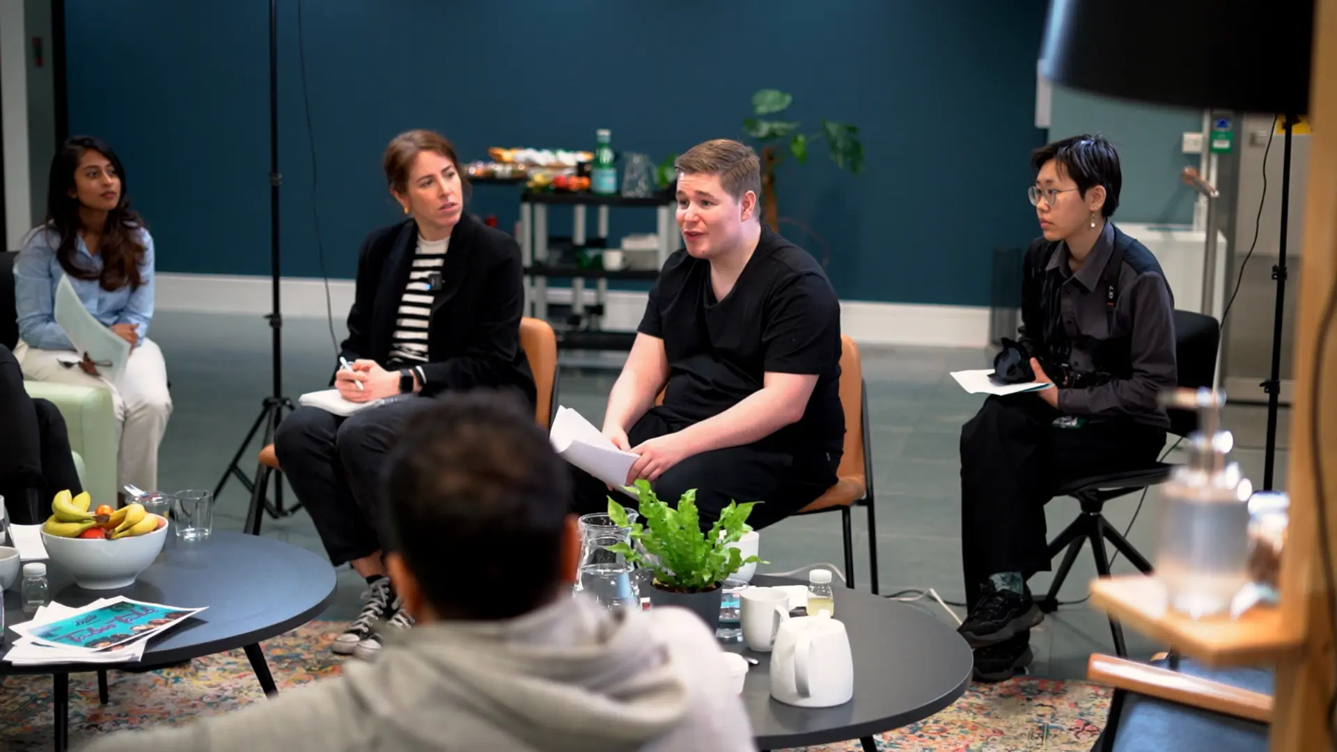 A panel discussion being filmed in a bright studio space
